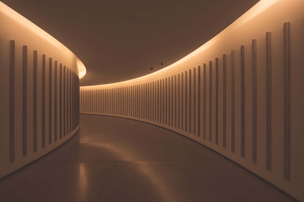 Curved interior lighting corridor with warm ceiling lines